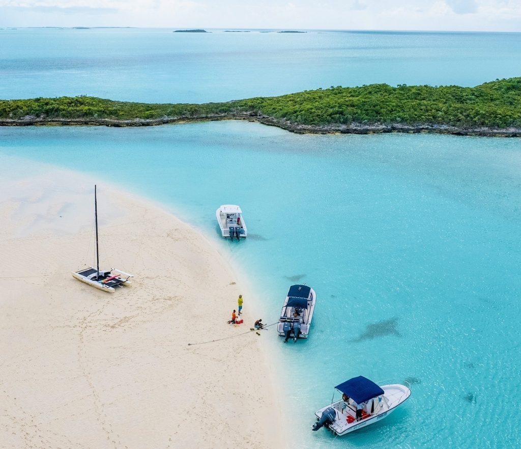 A group of boats docked on a beach in the Bahamas.