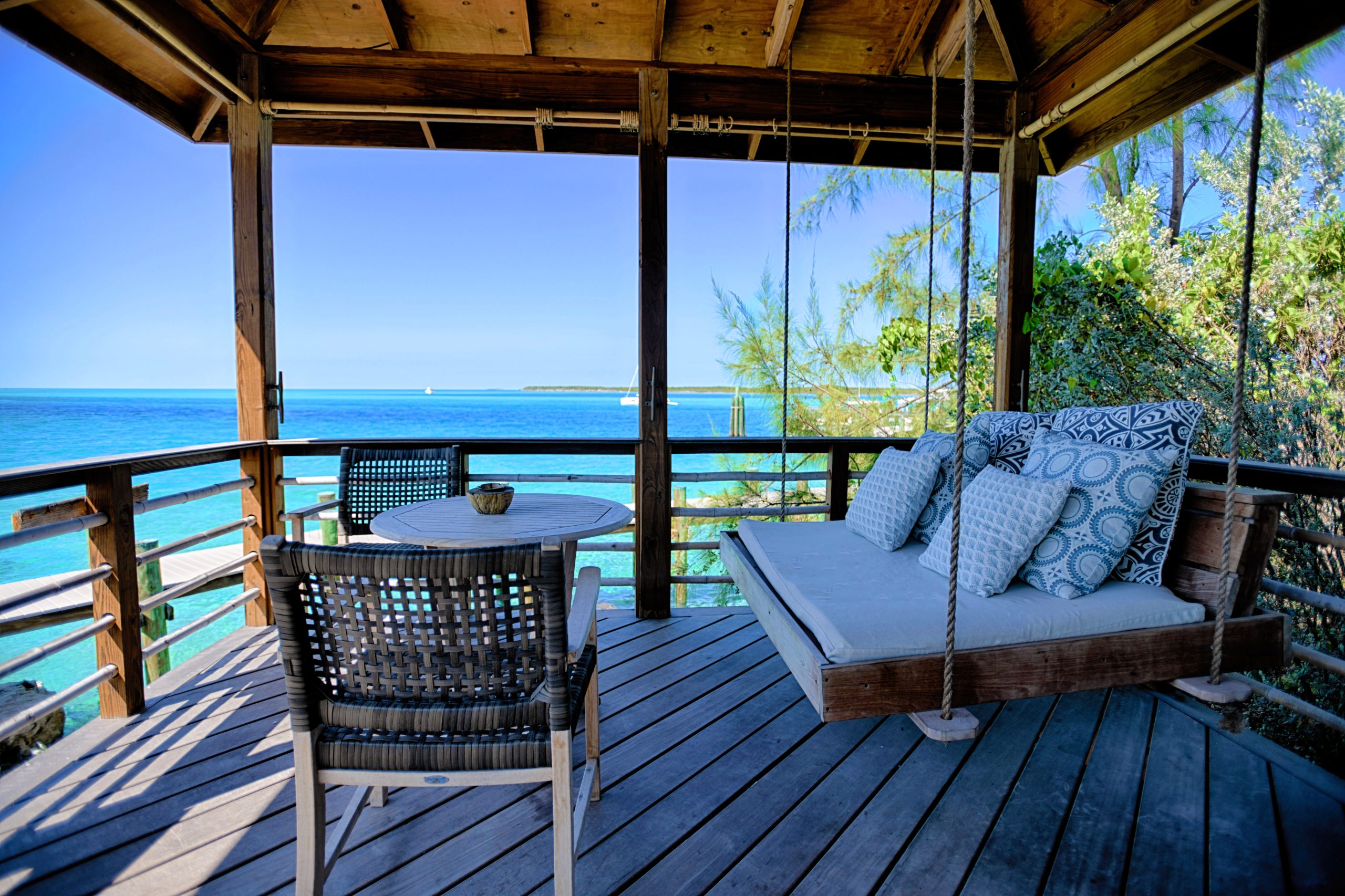 A porch with a swing and a view of the ocean at Staniel Cay.